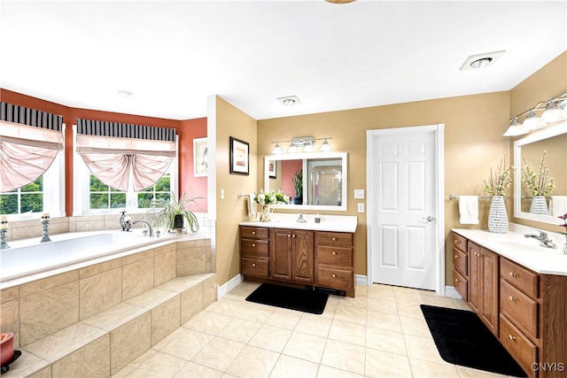 bathroom with vanity, tile patterned floors, and a relaxing tiled tub