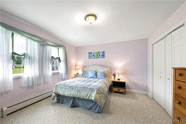 carpeted bedroom featuring a closet and baseboard heating