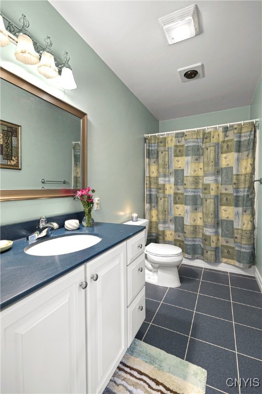 bathroom with vanity, tile patterned floors, and toilet