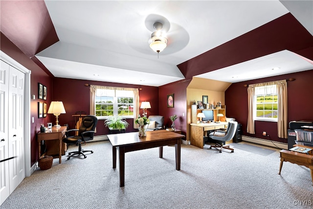 carpeted office featuring a baseboard heating unit, lofted ceiling, a healthy amount of sunlight, and ceiling fan