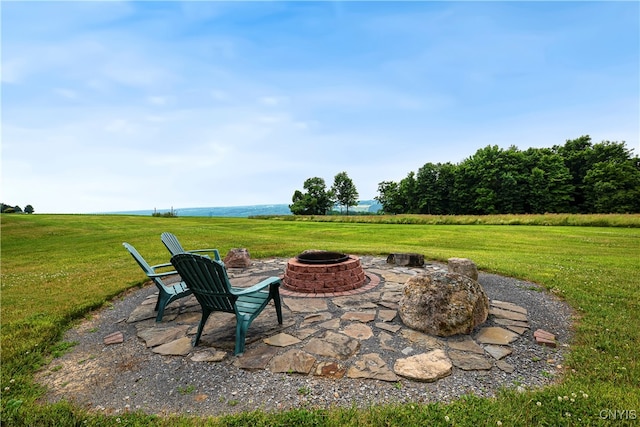 view of patio featuring a rural view and an outdoor fire pit