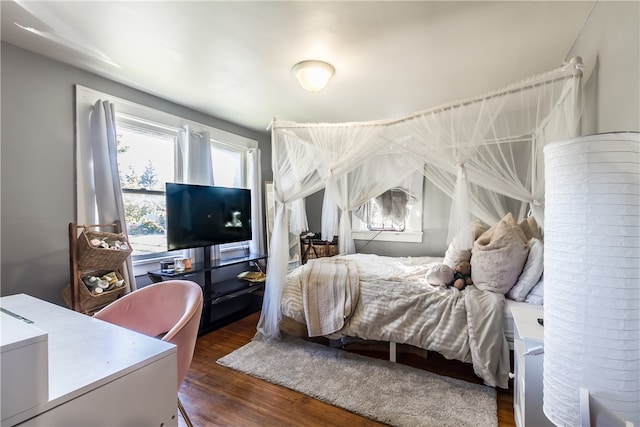 bedroom with dark hardwood / wood-style floors