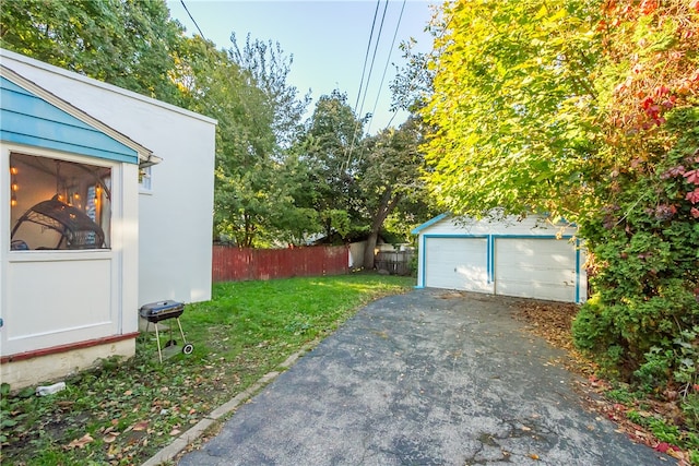 view of yard featuring an outbuilding and a garage