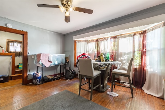 dining space with hardwood / wood-style floors, ceiling fan, and crown molding