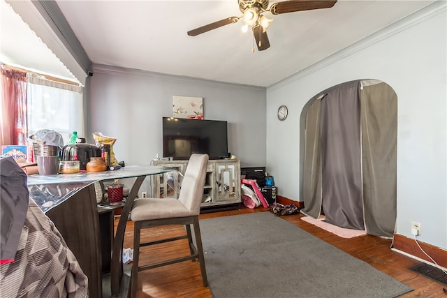 interior space featuring dark hardwood / wood-style flooring, ceiling fan, and crown molding