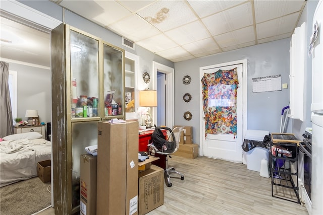 home office featuring light hardwood / wood-style floors and crown molding