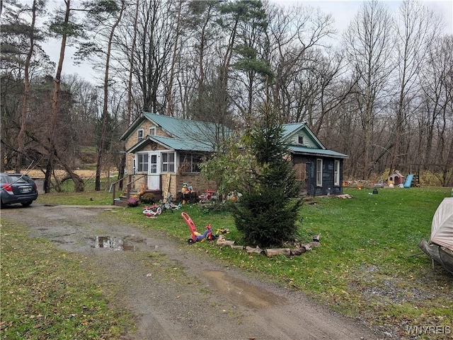 3831 Creek Rd, Yorkshire, NY 14030 - bungalow featuring metal roof, a front lawn, and dirt driveway
