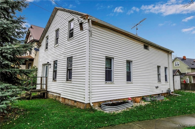 view of side of home with a lawn