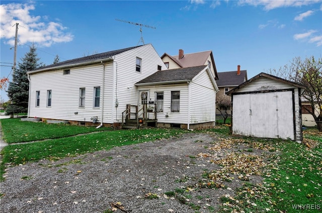 back of property featuring a lawn and a shed