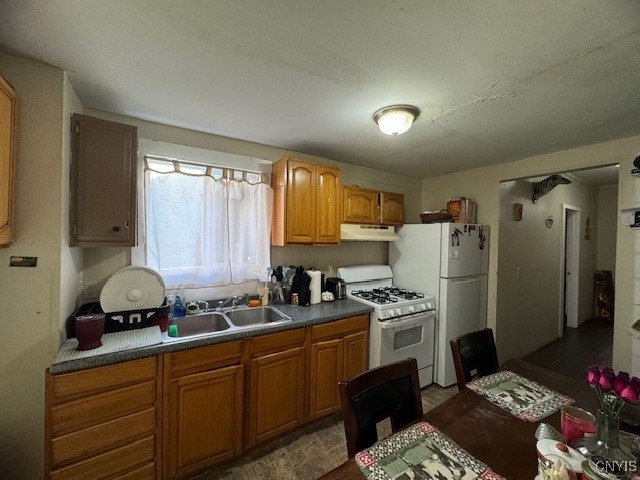 kitchen featuring white appliances and sink