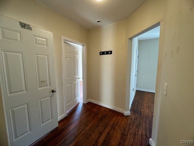 hallway with dark hardwood / wood-style flooring