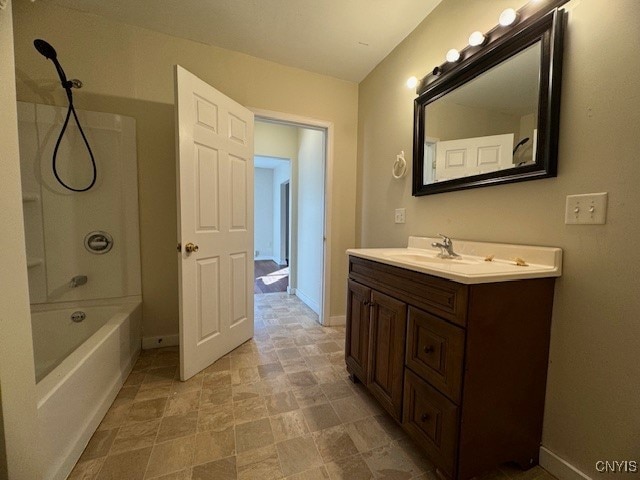 bathroom with washtub / shower combination and vanity