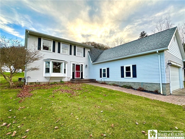 view of front of home featuring a garage and a lawn