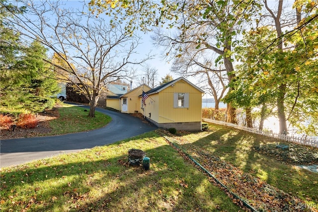 view of home's exterior with a yard