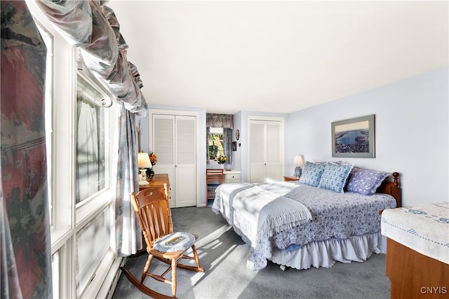 bedroom featuring carpet and two closets