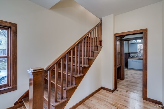 staircase featuring wood-type flooring and plenty of natural light