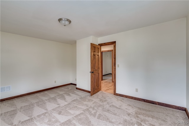 empty room featuring light colored carpet