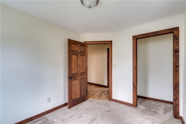 unfurnished bedroom featuring light colored carpet