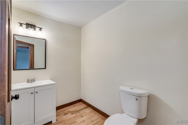 bathroom featuring hardwood / wood-style floors, vanity, and toilet