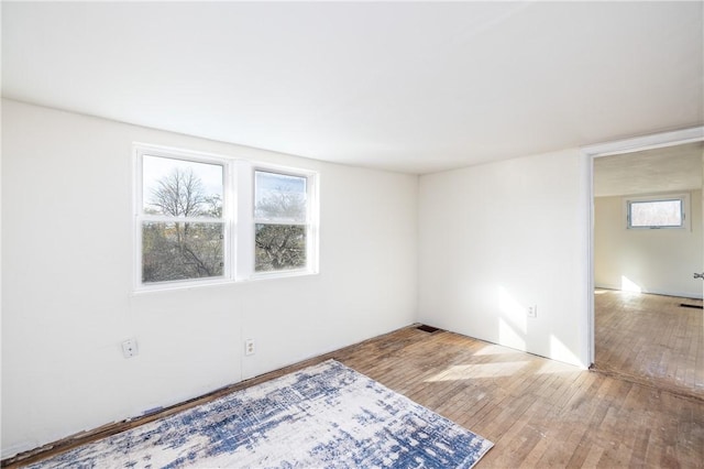 unfurnished room with hardwood / wood-style floors