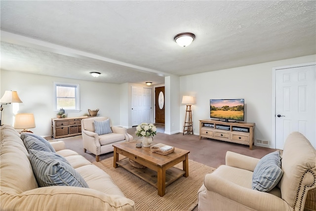 carpeted living area with baseboards and visible vents