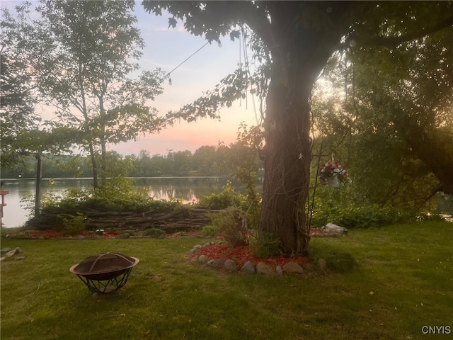 yard at dusk with a water view