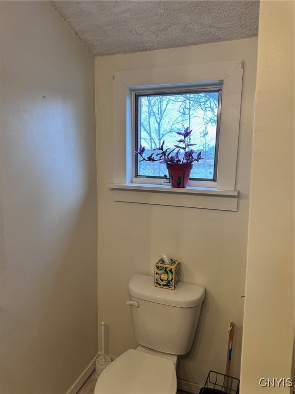 bathroom featuring a textured ceiling and toilet