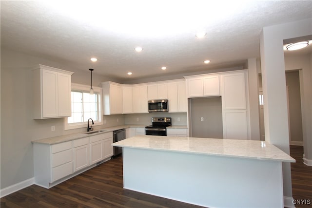 kitchen with white cabinetry, sink, dark hardwood / wood-style floors, and stainless steel appliances