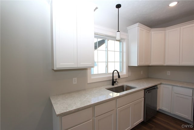 kitchen featuring sink, light stone countertops, hanging light fixtures, white cabinets, and dishwasher