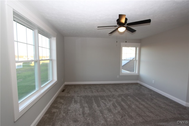 carpeted spare room with ceiling fan and a textured ceiling