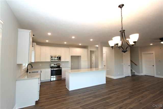 kitchen with white cabinetry, appliances with stainless steel finishes, and dark hardwood / wood-style floors