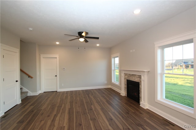 unfurnished living room with dark wood-type flooring and ceiling fan