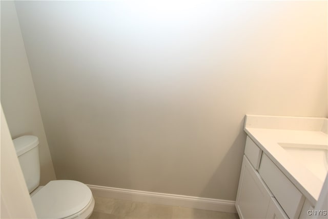 bathroom with vanity, tile patterned floors, and toilet