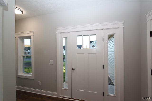 entrance foyer with dark wood-type flooring and a textured ceiling