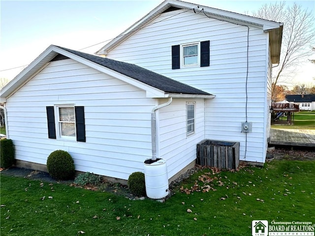 back of house with a lawn