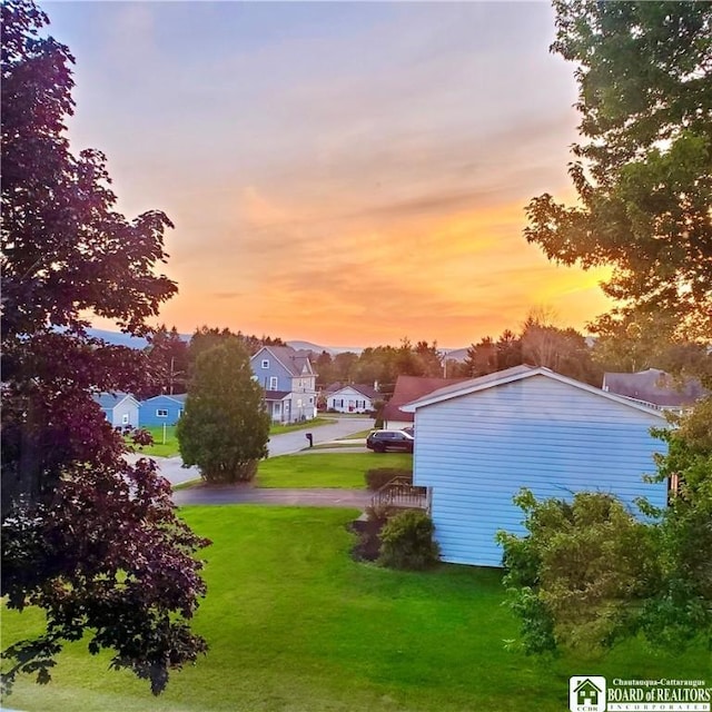 view of yard at dusk