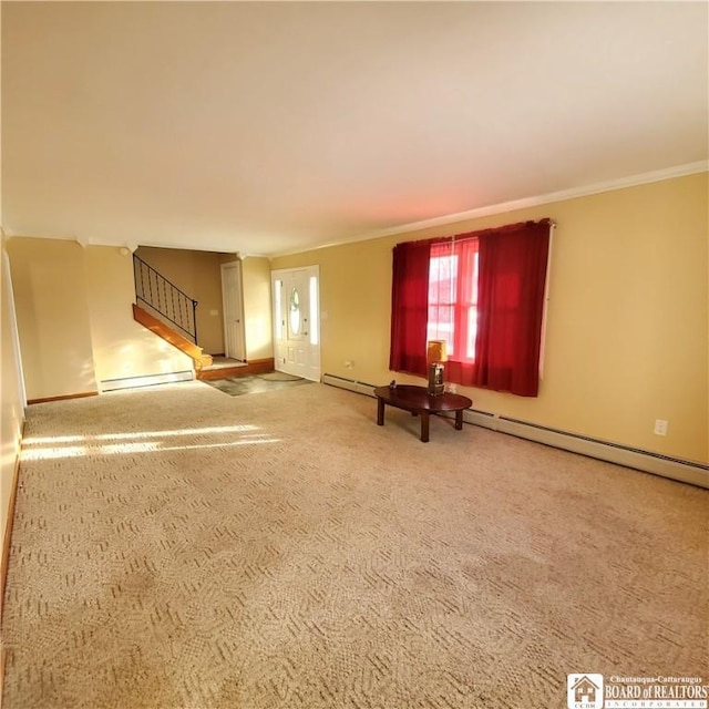 unfurnished living room featuring baseboard heating, ornamental molding, and carpet flooring