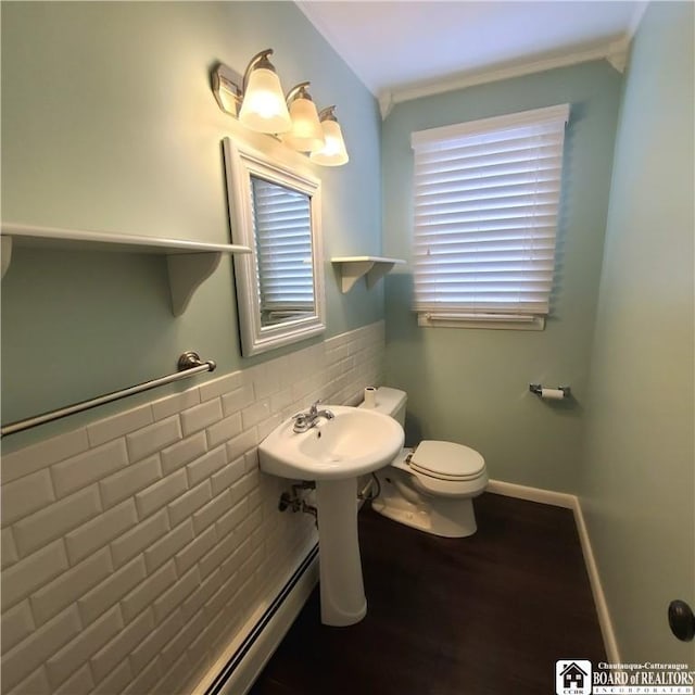 bathroom featuring tile walls, hardwood / wood-style flooring, and toilet