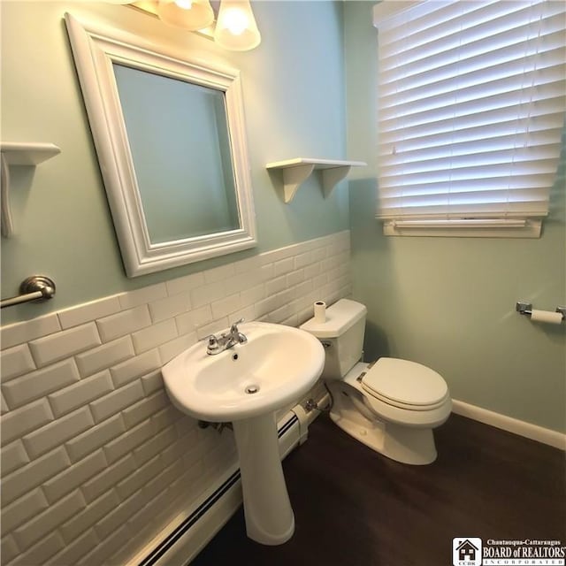 bathroom featuring tile walls, sink, hardwood / wood-style flooring, and toilet