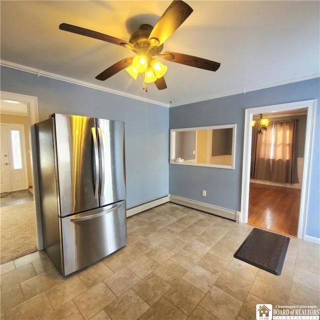 kitchen featuring baseboard heating, ceiling fan, ornamental molding, and stainless steel fridge