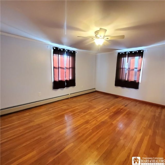 unfurnished room with hardwood / wood-style flooring, ornamental molding, ceiling fan, and baseboard heating