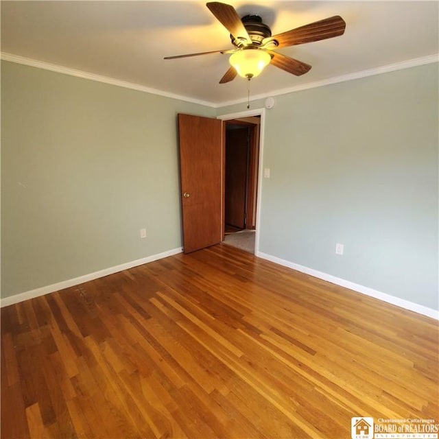 empty room with ceiling fan, ornamental molding, and wood-type flooring