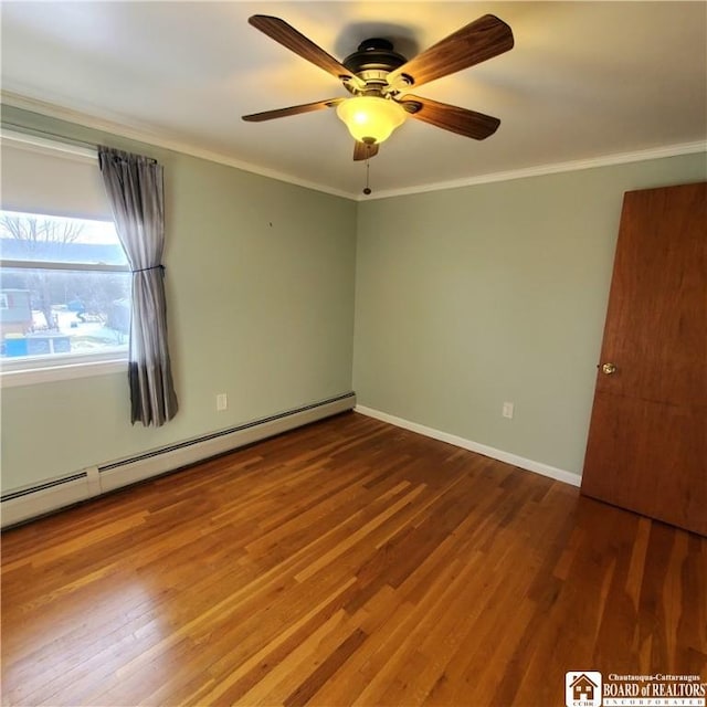 empty room featuring baseboard heating, ceiling fan, crown molding, and hardwood / wood-style flooring