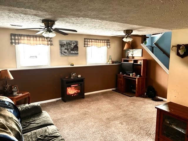 carpeted living room with a textured ceiling and ceiling fan