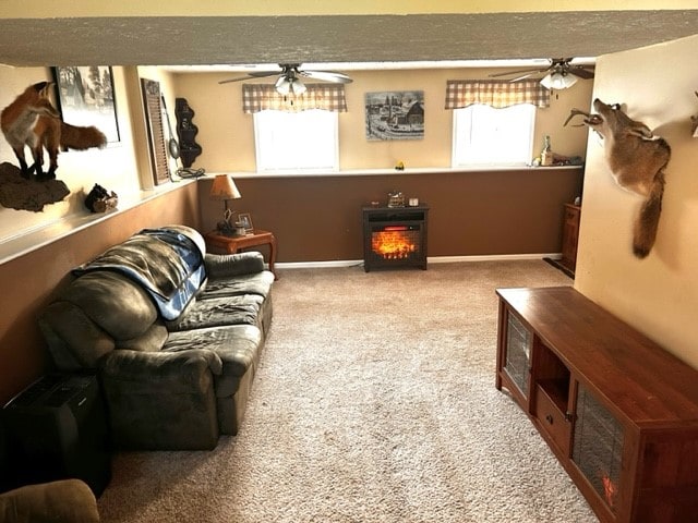 carpeted living room with a textured ceiling and ceiling fan