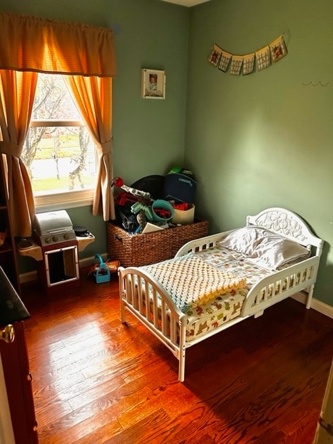 bedroom with hardwood / wood-style flooring