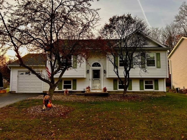 view of front of property with a garage and a front yard