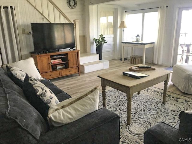 living room with a wealth of natural light and light hardwood / wood-style flooring