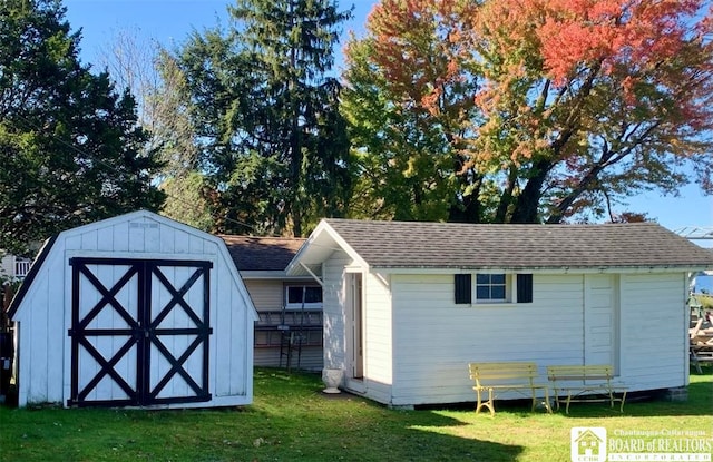 view of outbuilding featuring a yard