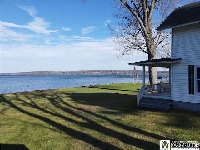 view of yard with a deck with water view